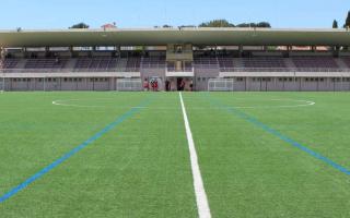 France: 20th-century stadium modernized. Monolithic structure in terracotta tones